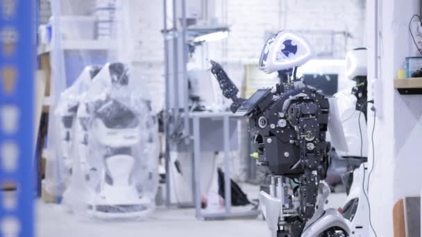 Robô desmontado em produção. O robô está pronto para montagem, ele testa todos os sistemas. Instalação para a produção de robôs . — Vídeo de Stock