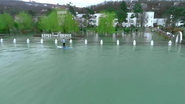 Anapa Rusland - 19.01.2019: Twee renners drijven op de sup surfplanken. Zwemmen tussen de bomen in het oude overstroomd park. Leren surfen. Sup — Stockvideo