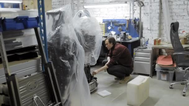 Fabrik für die Produktion von Robotern. untersucht der Ingenieur den Roboter. erstellt einen neuen Roboter im Labor. Reparatur von Roboterteilen. — Stockvideo