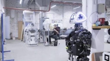 Fabrika Robotlar üretimi için. Robot değer, gülümseyen demonte