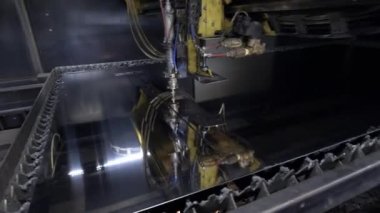 Atölyedeki metal levhayı kes. Ağır sanayide modern bir araç. Tehlikeli bir iş. Yüksek hassasiyetli çelik parçaları üretimi. Kapalı alanda işlemin otomasyonu. Demircilik için otomatik çalışma. Bilgisayar cnc 'yi kapat