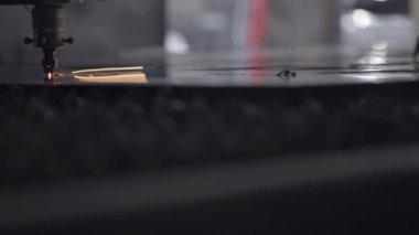 Atölyede sac kesme. Ağır sektörde modern bir araçtır. Tehlikeli bir iş. Çelik parçaların yüksek hassasiyetli imalatı. Metal, modern endüstriyel makine CNC lazer kesim. Küçük alan derinliği.