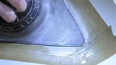 Far parlatma, Araba ışıkları işleme. Bir araba servis işçisi özel bir parlatma aracı ile bir binek aracın Far parlatır. Profesyonel parlatma