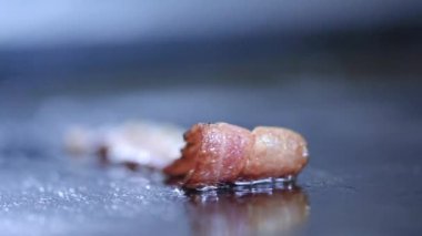 Yakın çekim Bacon dilimleri sıcak ızgara üzerinde ızgara. Profesyonel bir mutfak kızartmaları bir aşçı ve pastırma dilimleri döner