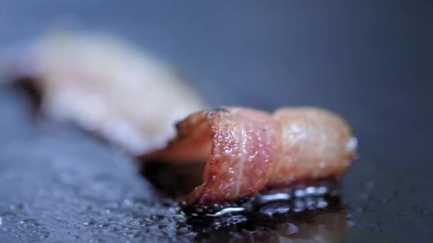 뜨거운 그릴에 구운 베이컨 조각의 클로즈업. 전문 부엌 감자 튀김에 요리사와 베이컨 슬라이스를 켭니다 — 비디오