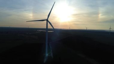 Rüzgar türbinleri günbatımı arka planında. Döngü. Rusya, Kırım 'da alternatif yenilenebilir enerji üretimi. Çevreyi ve doğayı önemsemek. Yeni enerji teknolojileri.