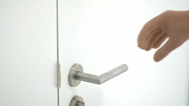 En funktionshindrad person utan arm med protes öppnar dörren. Robotarm protesen tar dörrhandtaget. Normal full livslängd med protes. — Stockvideo