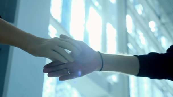 A disabled person without a hand with a prosthesis shakes hands with a business partner. Handshake prosthesis on the background of a large window in the business center. Full life with a prosthesis. — Stock Video