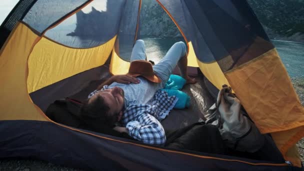 Genç yakından görmek kamp içinde yalan bacak çiftler çadır ayaklı katıldı gün hiking sonra dinlenme süre. Güzel deniz manzaralı zevk ve akşam rahatlatıcı mutlu aşıklar. — Stok video