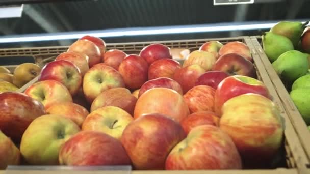 リンゴの赤と緑がたくさん。リンゴの束は、スーパーマーケットに横たわっています, カメラのスパン — ストック動画