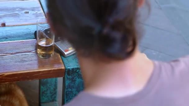 Giovane viaggiatore maschio barbuto o turista in un caffè o ristorante applica una carta di credito con il modulo NFC. Paga con moneta elettronica, carta senza contatto. Utilizza un terminale per il pagamento senza contanti — Video Stock