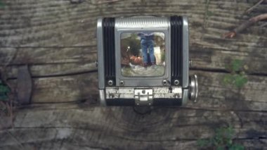 Vintage Tlr Twin lens refleks kamera vizörü ile ilk kişi görünümü. Eski vintage film kamerası. Eski bir arka plandaki kamera. Görüntüodaklanmak, kız bir köpek ile raylar üzerinde gidiyor