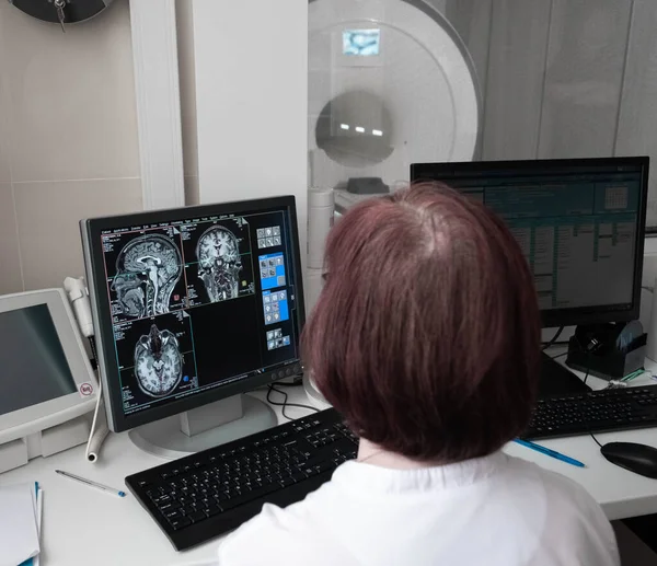 Professional Scientists Work in the Brain Research Laboratory. Neurologists Neuroscientists Surrounded by Monitors Showing CT, MRI Scans Having Discussions and Working on Personal Computers. Stock Photo