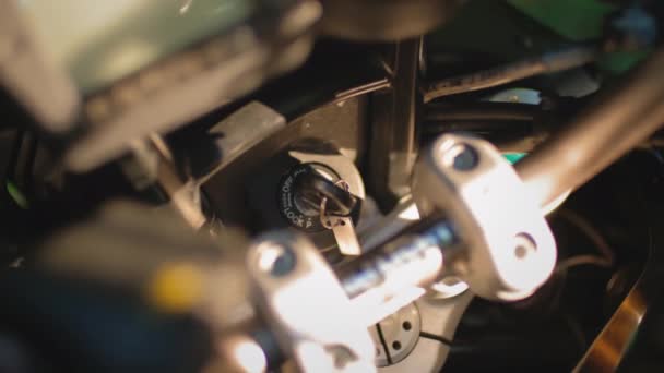 El motociclista gira la llave de encendido de la motocicleta. Enciende o arranca la moto. Preparación para un viaje en bicicleta — Vídeos de Stock