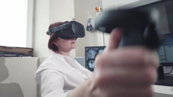 Un médico de verdad realiza una resonancia magnética para un paciente en la clínica. Utiliza la tecnología de realidad virtual en medicina, realidad aumentada. Imágenes por resonancia magnética en el estudio del cuerpo humano. — Vídeo de stock