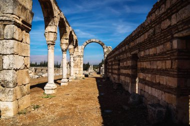 Archway in Umayyad city ruins in Anjar with mountains, Bekaa valley, Lebanon clipart