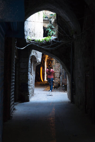 Man preparing the coals for the shisha in the souks of Sidon, Lebanon