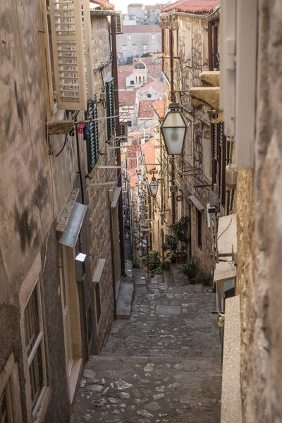 Narrow medieval alley with downstairs view in Dubrovnik in winter, Croatia