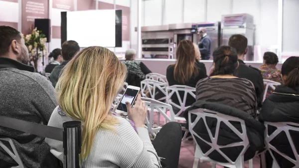 Woman and people Listening on The Conference. Woman with a smartphone