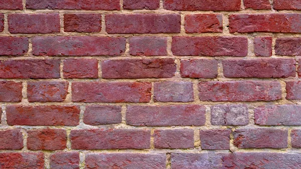 brick wall of dark color, wide panorama of masonry