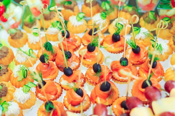 Background of party appetizers on wooden sticks