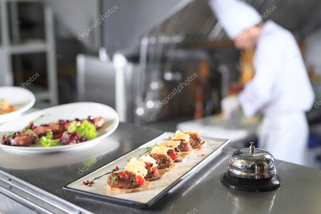 served dish on distribution table in kitchen of restaurant