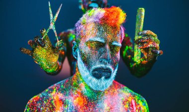 Kavram. Berber dükkanında sakallı bir adam. Berber dükkanında şık bir sakallı adam kesilmiş. Adam ultraviyole tozu ile dekore edilmiştir.