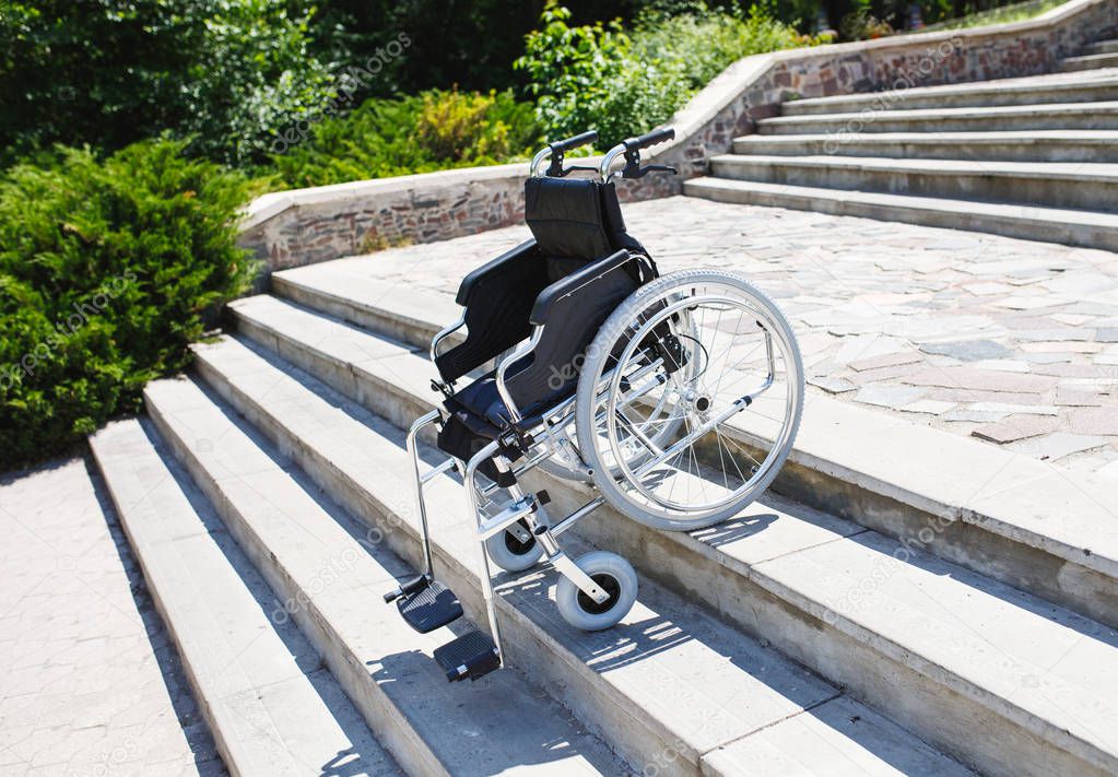 empty wheelchair on steps outdoors