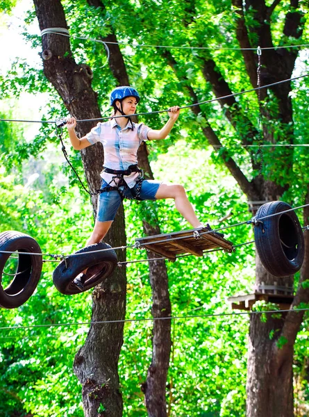 Kalandmászás magas vezetékes park - emberek természetesen hegyi sisak és biztonsági berendezések — Stock Fotó