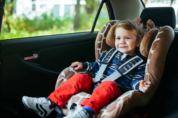 Adorable baby boy in a safety car seat. — Stock Photo, Image