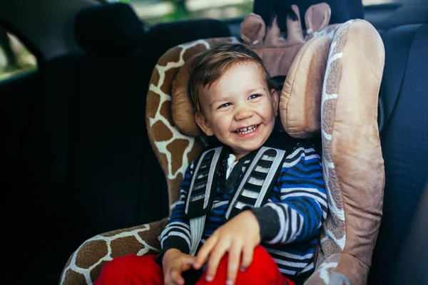 Adorable baby boy in a safety car seat. — Stock Photo, Image