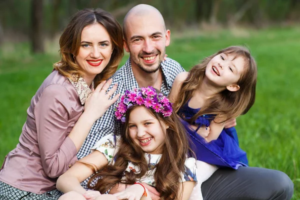Happy family portrait in a summer park. — Stock Photo, Image