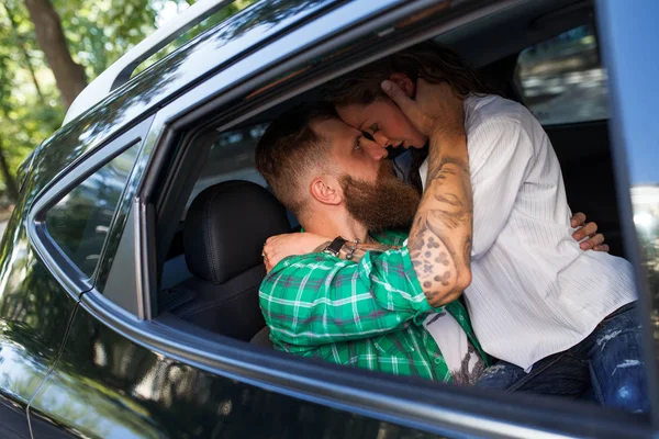 Couple make love in the car in the summer park