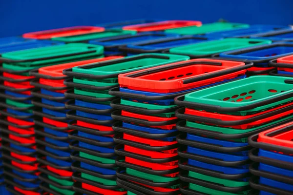 Multicolored empty shopping baskets in the supermarket Stock Photo