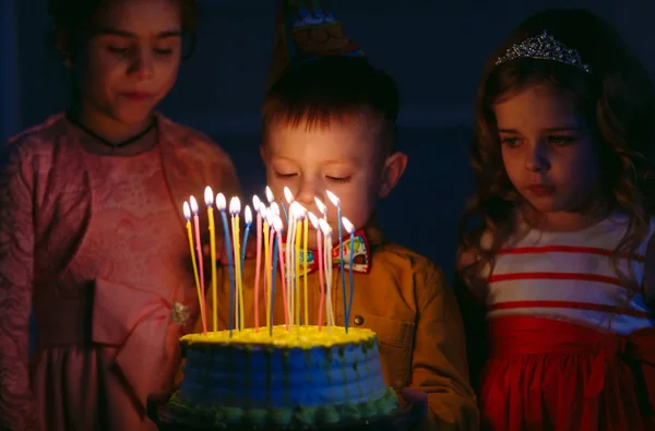 Kindergeburtstag. Kinder neben einer Geburtstagstorte mit Kerzen — Stockfoto
