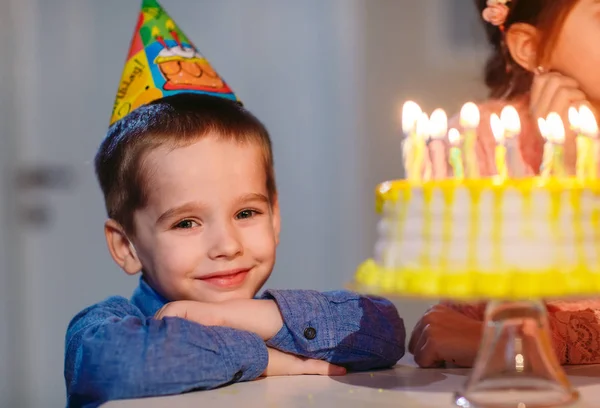 Childrens birthday. Children near a birthday cake with candles — Stock Photo, Image