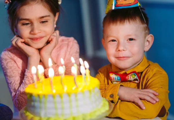 Barnens födelsedag. Barn nära en födelsedagstårta med ljus — Stockfoto