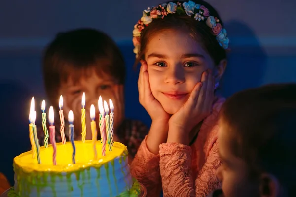 Childrens birthday. Children near a birthday cake with candles. — Stock Photo, Image