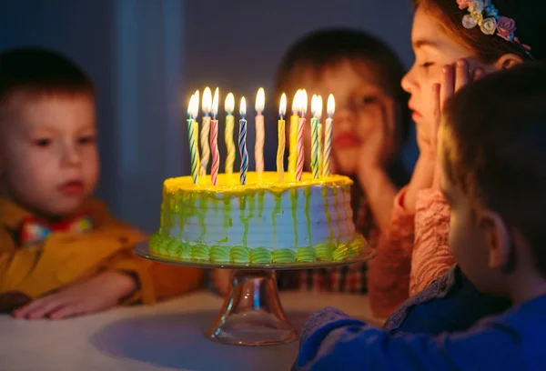 Compleanno dei bambini. Bambini vicino a una torta di compleanno con candele . — Foto Stock