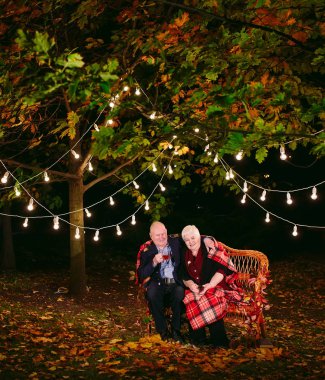 Mutlu yaşlı çift kanepede oturan akşam çay içme