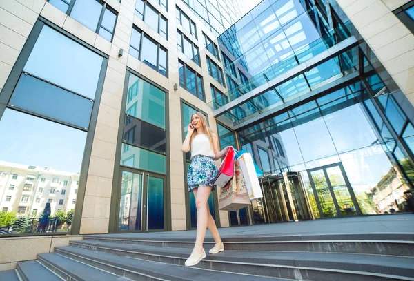 Životní styl portrét mladá blonďatá dívka s nákupníma taškama z obchodu — Stock fotografie