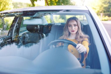 Genç güzel bir kız araba kullanıyor..