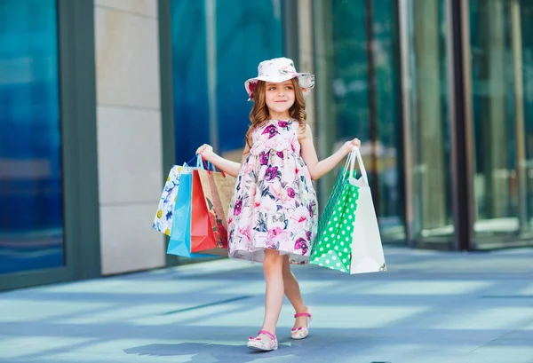 Cute little girl on shopping. Portrait of a kid with shopping bags. Shopping. girl