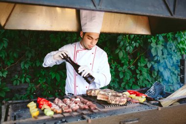 Şef barbeküde et hazırlıyor..