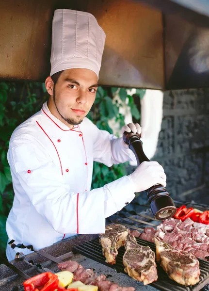 Lo Chef prepara carne al barbecue. — Foto Stock