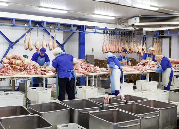 A cortar carne no matadouro. A fábrica de carne e salsicha . — Fotografia de Stock