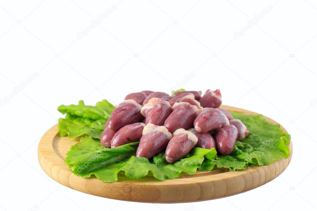 raw chicken hearts on white background on a wooden board