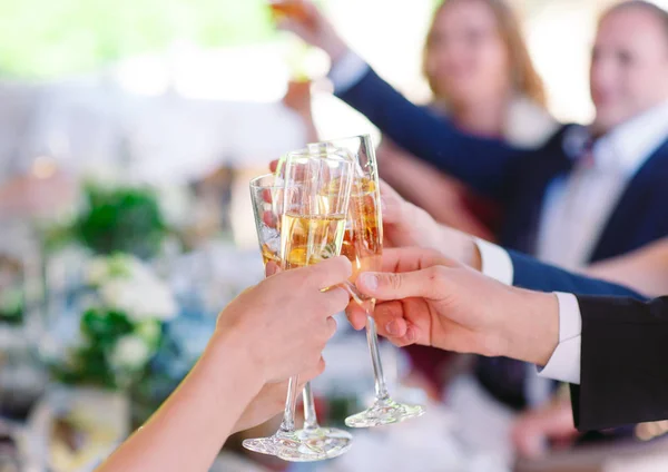 Hands holding glasses and toasting, happy festive moment. — Stock Photo, Image