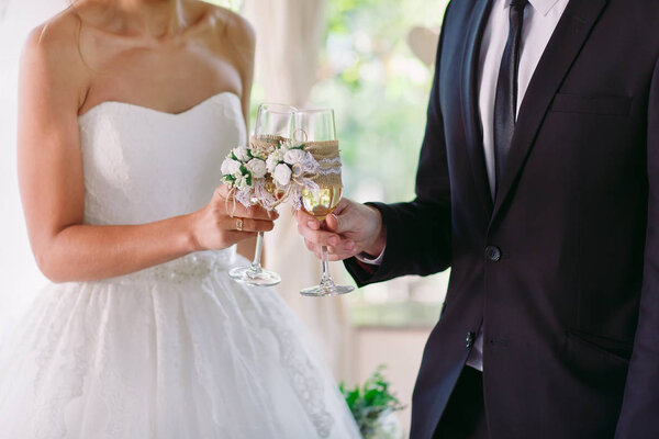 Bride and groom holding wedding champagne glasses