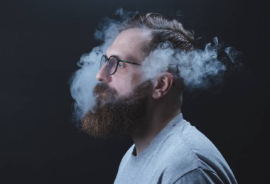 Kavram. Duman kafa adam sardı. Duman ile sakallı, şık bir adam portresi. İkinci el duman.